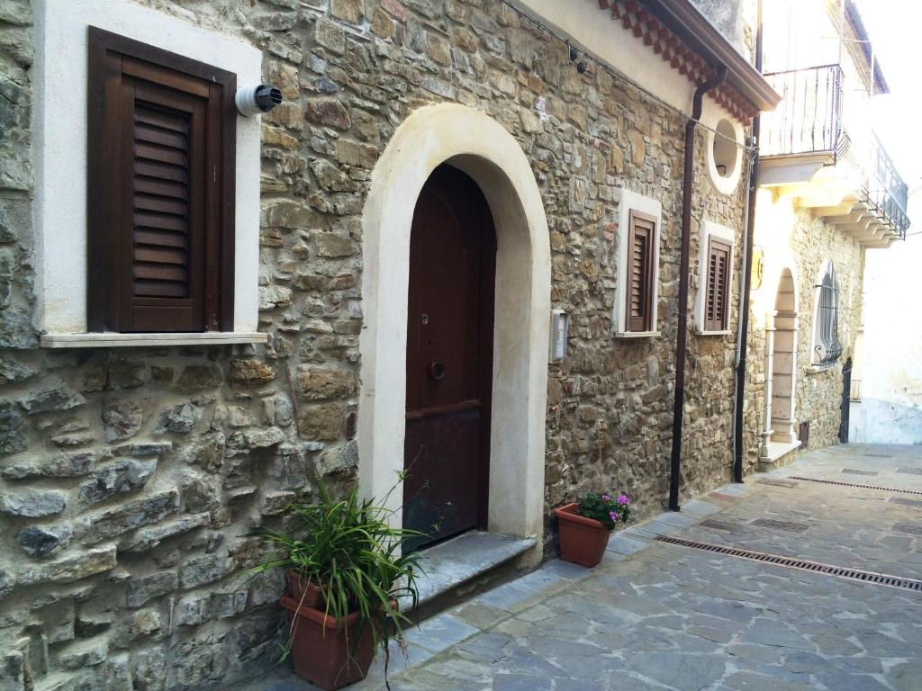 a stone building with a door and plants in front of it at Appartamenti Le Giare Cannicchio in Cannicchio