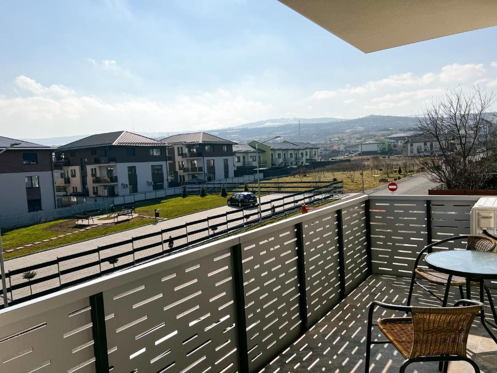 a balcony with a table and chairs and buildings at Apartament Cluj in Cluj-Napoca