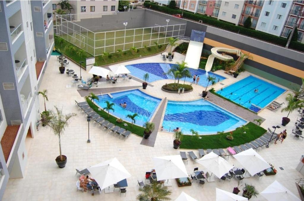 an overhead view of two swimming pools in a building at Veredas do Rio Quente Hotel Flat novo in Rio Quente
