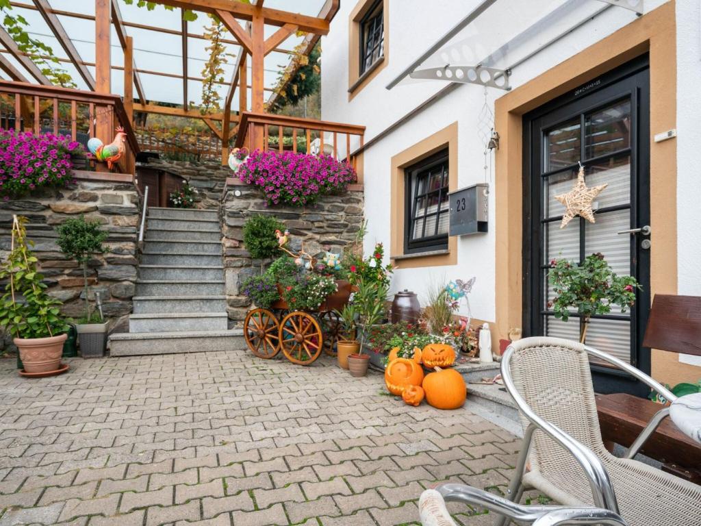 a patio with pumpkins in front of a house at Beautiful Apartment in Merschbach with Garden in Merschbach