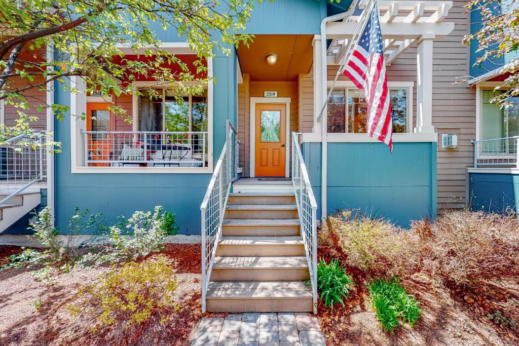 a blue house with an american flag on the front door at Sweet Retreat at Sweet Water in Hailey