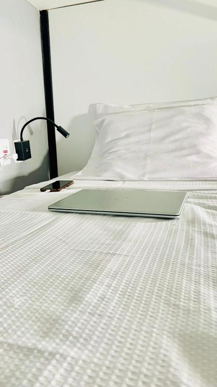 a laptop computer sitting on top of a bed at URB Hotel in Fortaleza