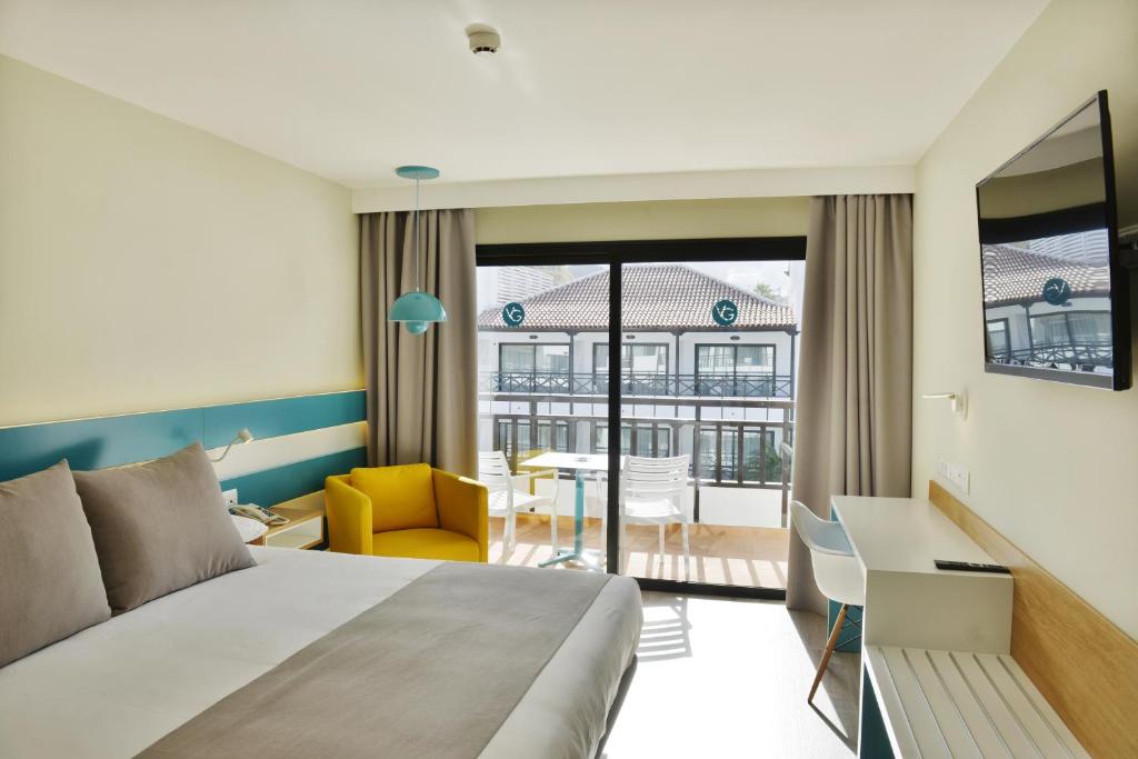 a hotel room with a bed and a desk at Vanilla Garden Boutique Hotel - Adults Only in Playa de las Americas