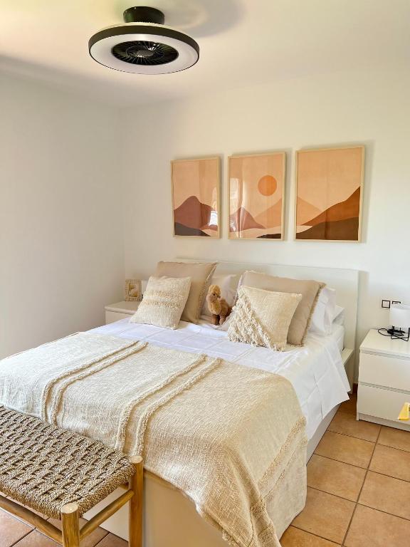 a bedroom with a large bed with white sheets at Villa Aloe in Lajares