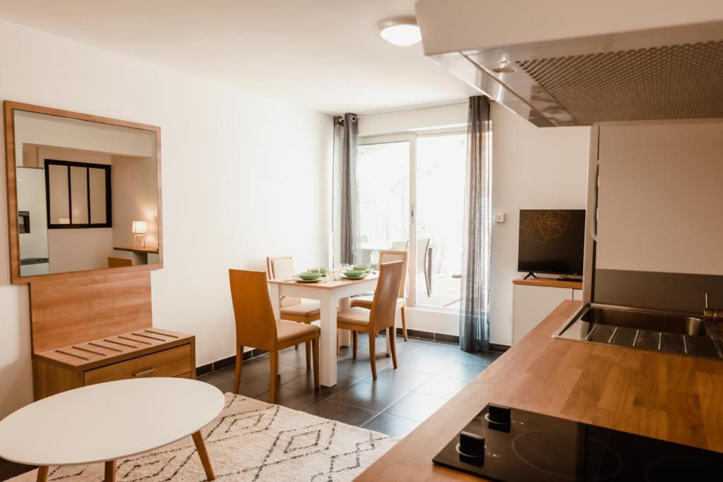 a kitchen and living room with a table and chairs at Calvi. T2 2/4 personnes à 100 mètres de la plage in Calvi