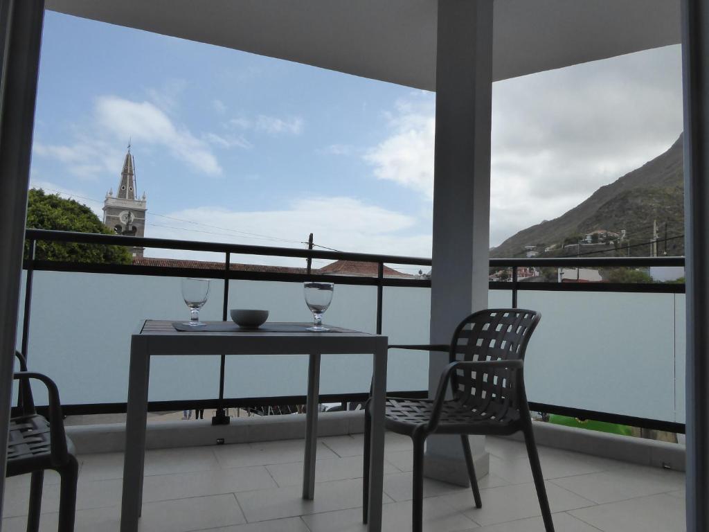 einen Tisch und zwei Stühle auf einem Balkon mit Aussicht in der Unterkunft La casa rosada (The pink house) in Tejina