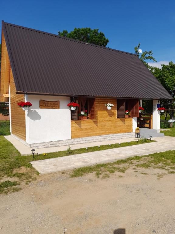 a wooden building with a black roof at Kuća za odmor Antonija in Gospić