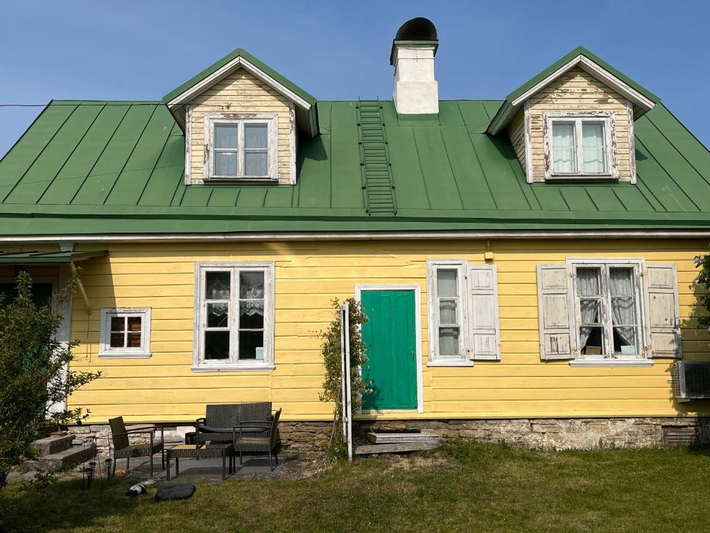 a yellow house with a green roof at Haapsalu Posti in Haapsalu