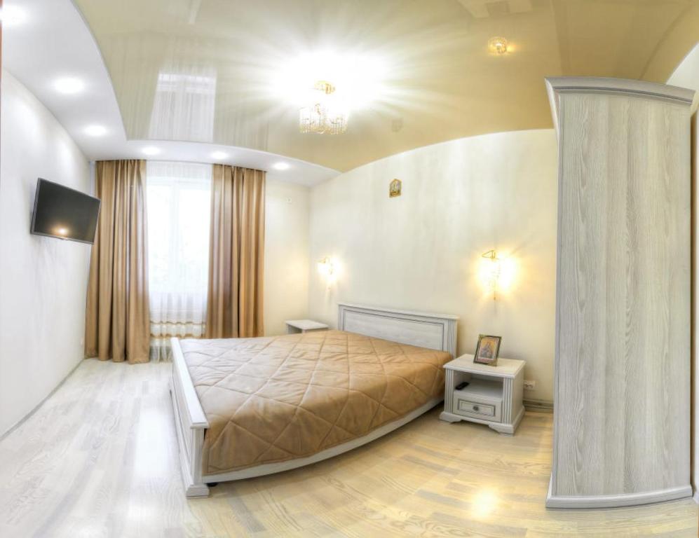 A bed or beds in a room at Апартаменти