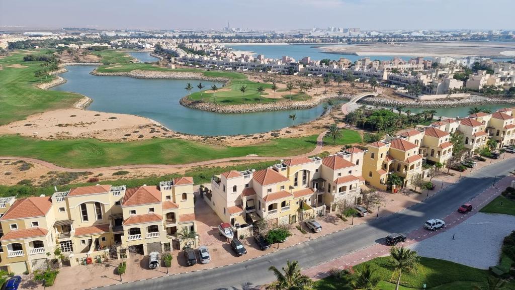 an aerial view of a resort with a river and houses at Great lagoon view 1 bedroom Flat in Ras al Khaimah