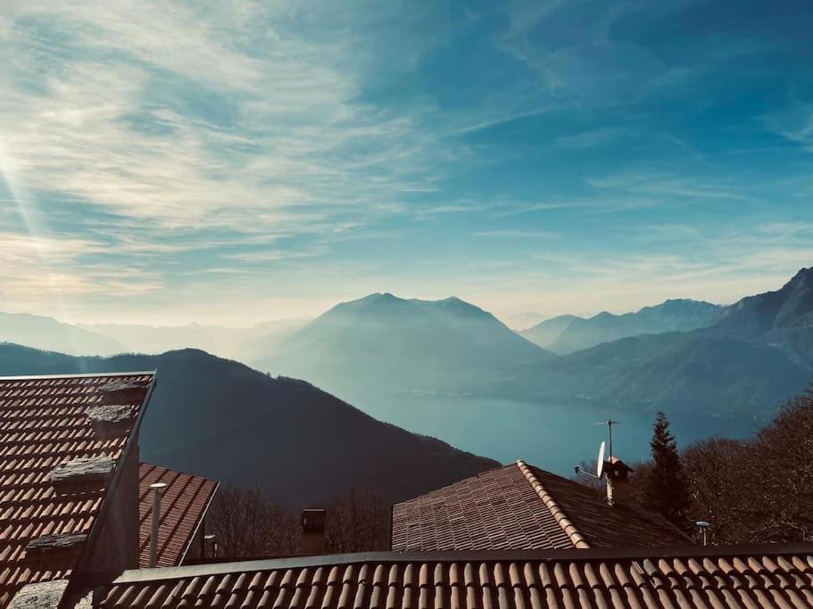 a view of the mountains from the roofs of houses at Chalet la terrazza vista lago in Bellano