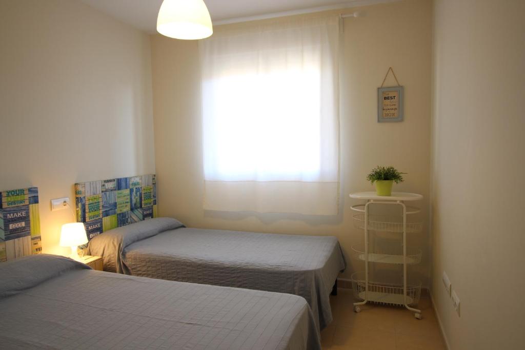 Postel nebo postele na pokoji v ubytování ÁTICO Paraíso Beach con piscina privada