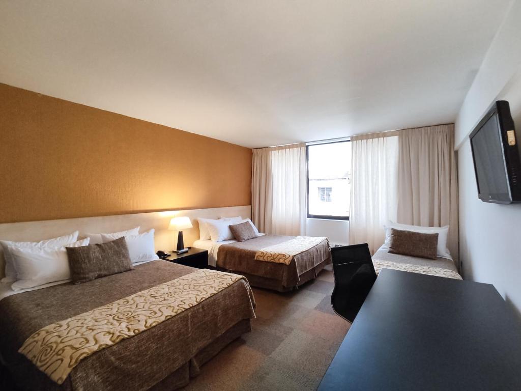 Postel nebo postele na pokoji v ubytování Hotel Alborada