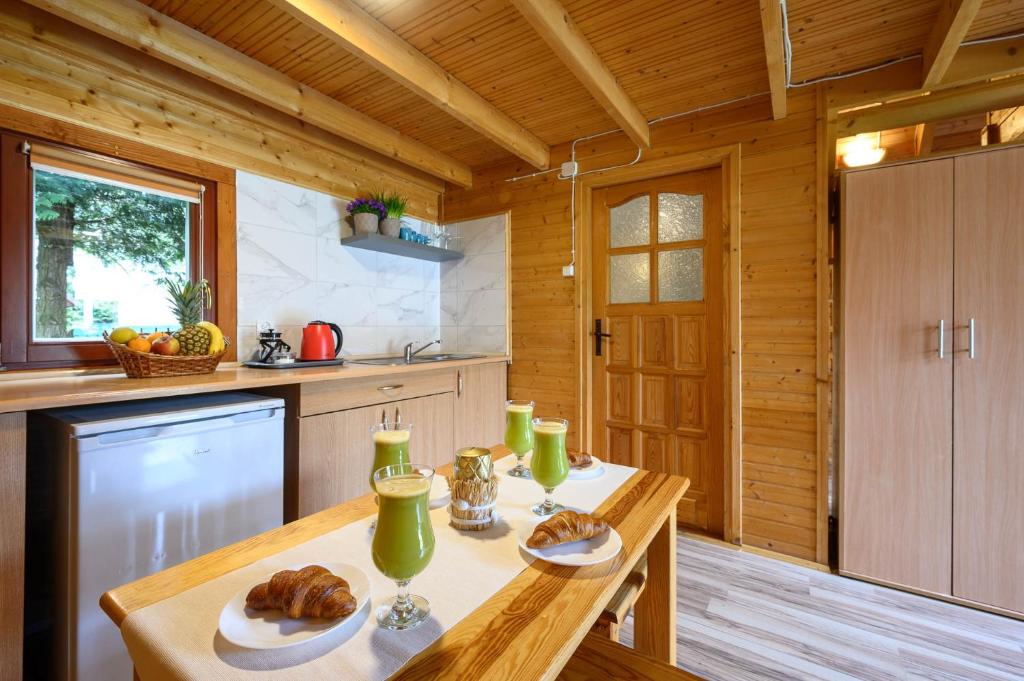 una cocina con una mesa con pan y bebidas. en Domki nad morzem - Nevada en Darlowko