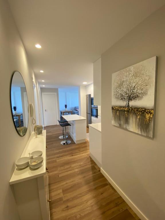 a living room with a desk and a painting on the wall at Apartamento Arousa Mar in Villanueva de Arosa