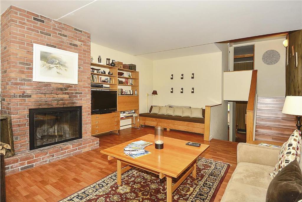 a living room with a couch and a fireplace at Notchbrook 2AB in Stowe