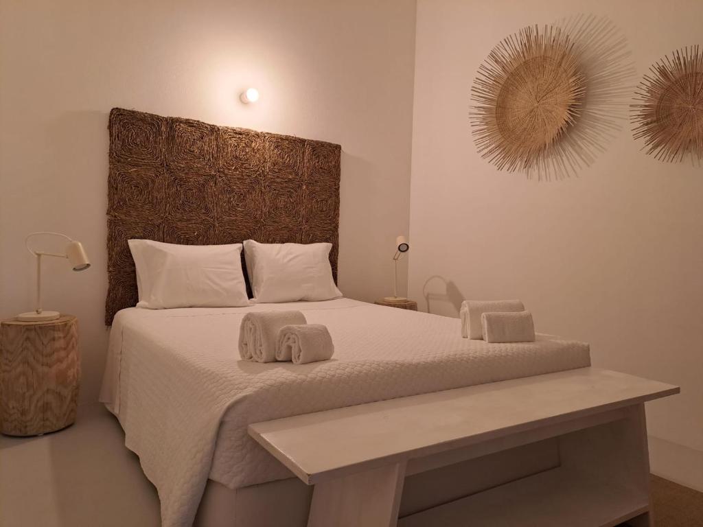 a bedroom with a large bed with two towels on it at Casa Atlântico Carvalhal Comporta, apartamento piscina aquecida in Carvalhal