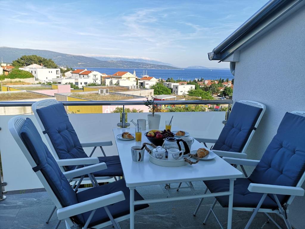 a table with a bowl of fruit on a balcony at Apartman The View Krk in Krk
