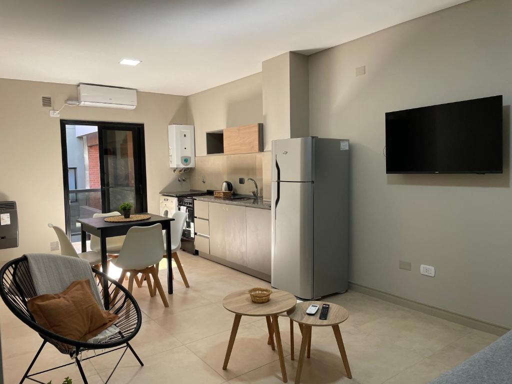 a living room with a refrigerator and a table with chairs at Departamento céntrico BELGRANO in San Salvador de Jujuy