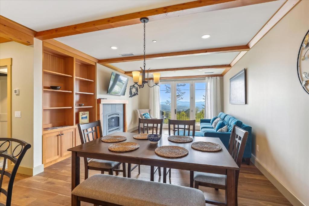a dining room and living room with a table and chairs at Trapp Hill View in Stowe