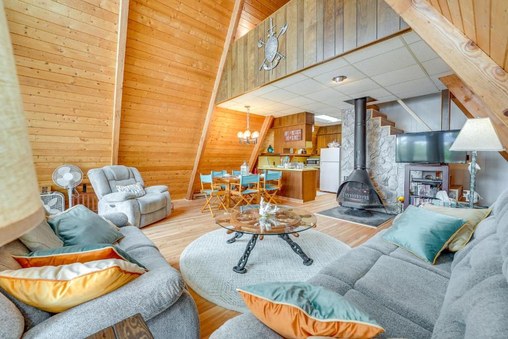 a living room with a couch and a table at Long Lake Cabin Rental with Private Dock! in Fountain