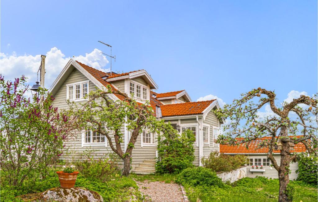 une maison blanche avec un toit orange dans l'établissement 4 Bedroom Beautiful Home In Eskilstuna, à Sundby