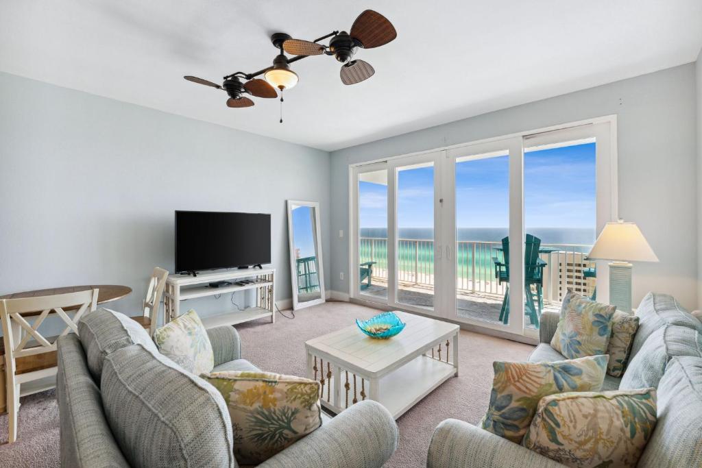 a living room with a view of the ocean at Laketown Wharf #1509 by Nautical Properties in Panama City Beach