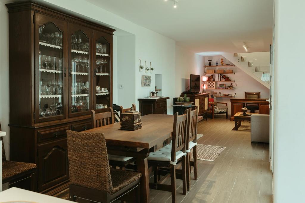 a dining room with a wooden table and chairs at Jack&Lily's in Évora