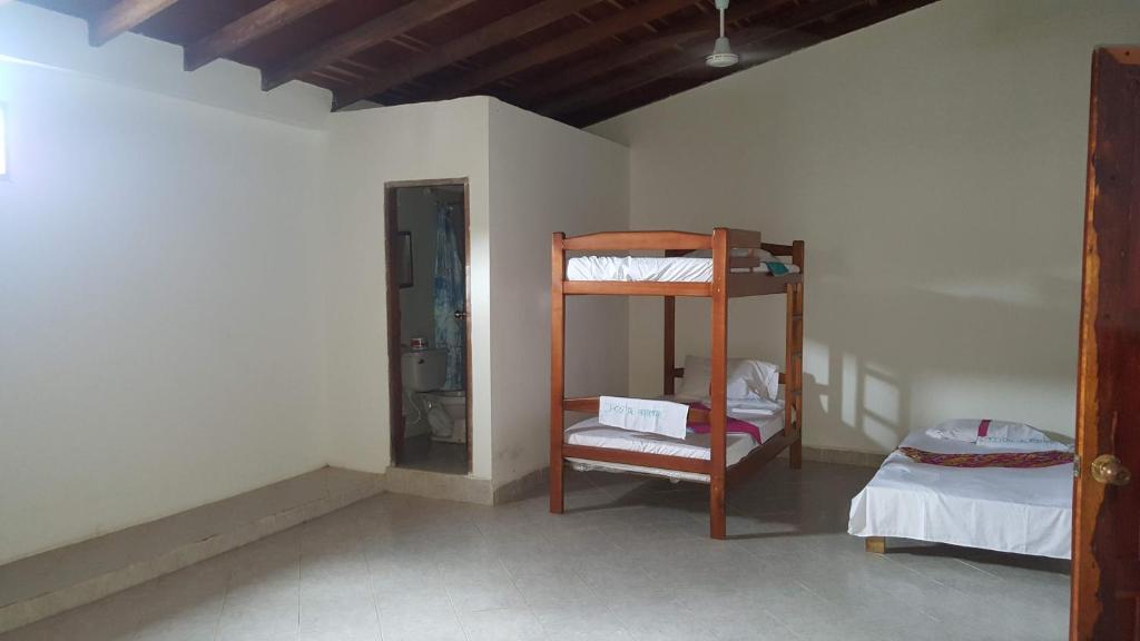 a room with two bunk beds and a bed at Alojamiento in Bahía Solano