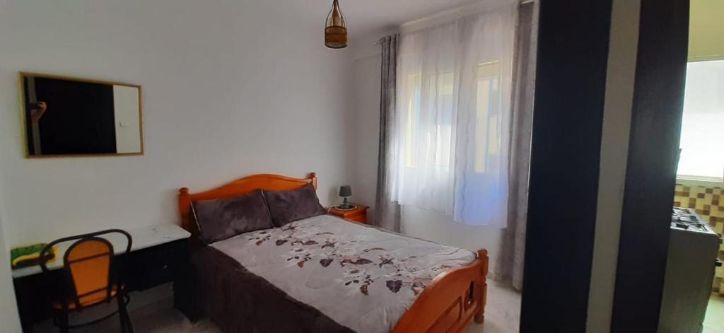 a bedroom with a bed and a desk and a television at RESIDENCE AL Hoceima 2 Minutes de prés de PLAGE CALABONITA in Al Hoceïma