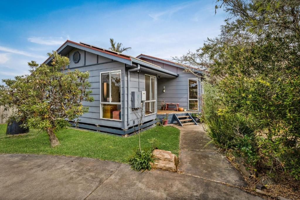 a small grey house with a yard at Calm 3922 in Surf Beach