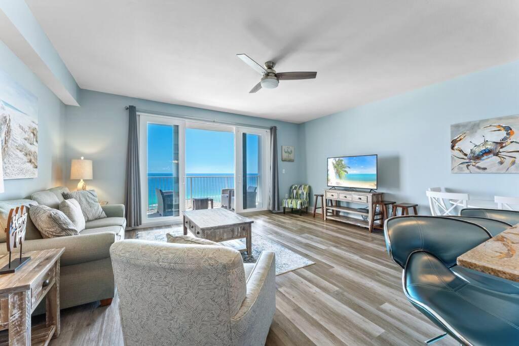 a living room with a couch and chairs at Beautiful Panama City Beach Condo- Ocean View! in Panama City Beach