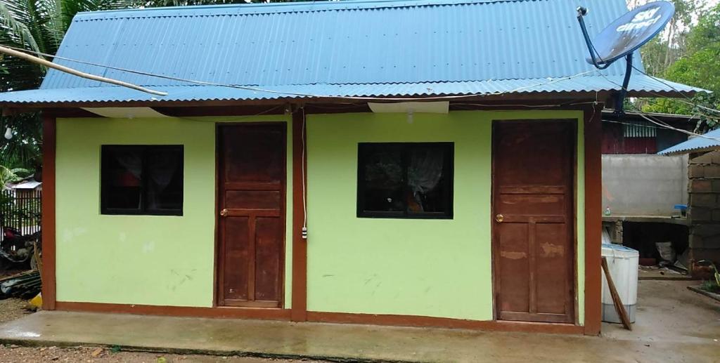 a small house with doors and a blue roof at Hondelz Budget Homestay in Busuanga