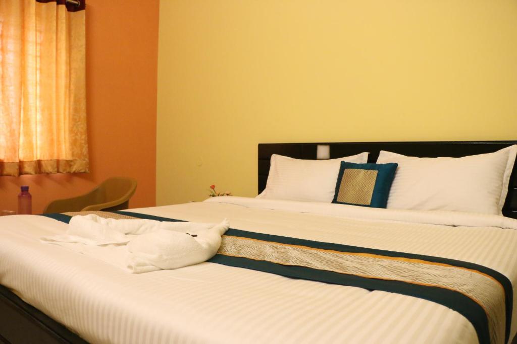 Postel nebo postele na pokoji v ubytování GT Residency-T Nagar