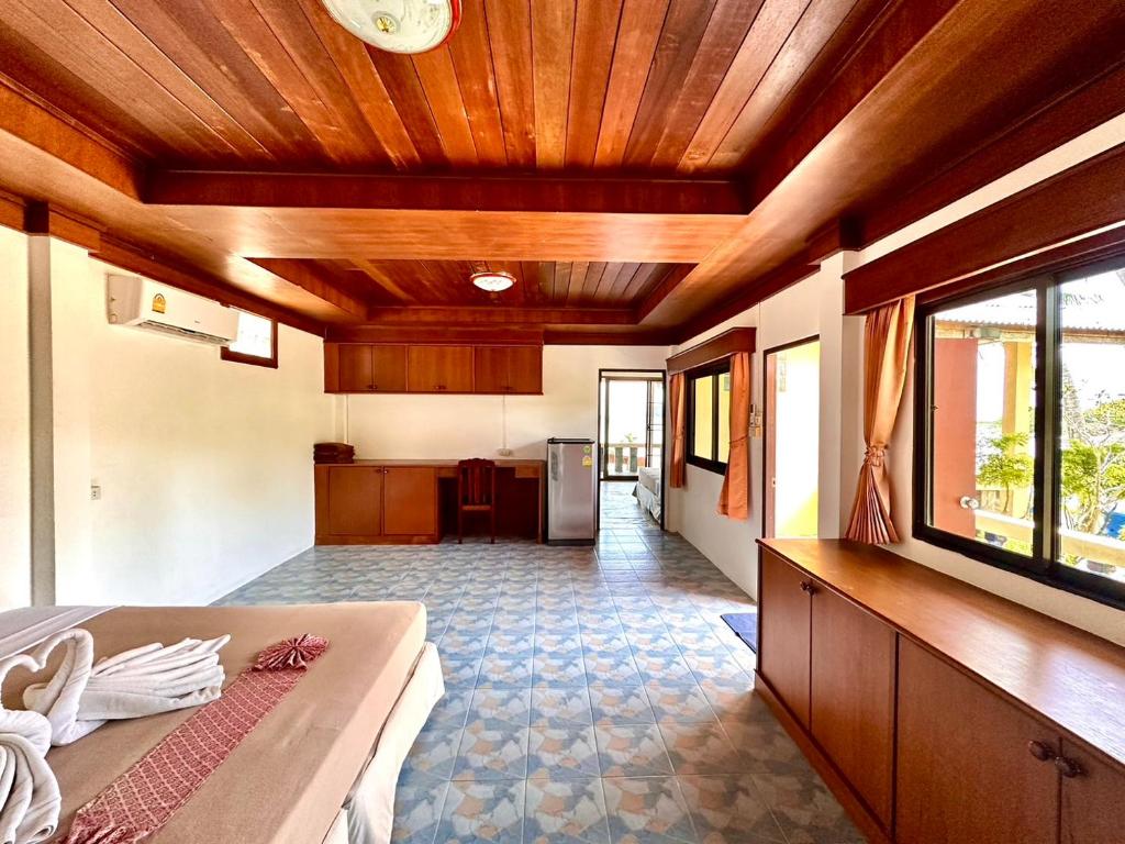 a room with a bed and a kitchen in it at Beck's Resort in Haad Pleayleam