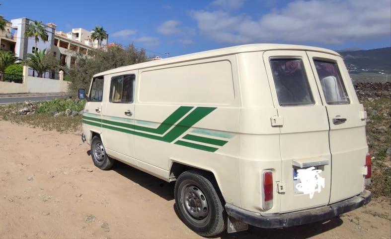 a white van parked on the side of a dirt road at canary van for drive, near to TFS Mercedes MB130 in Adeje