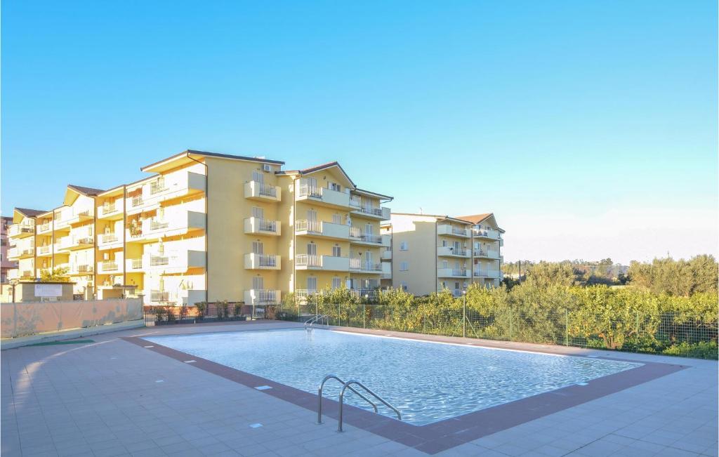 una piscina frente a un edificio de apartamentos en Lovely Apartment In Caulonia Marina With Jacuzzi, en Caulonia Marina