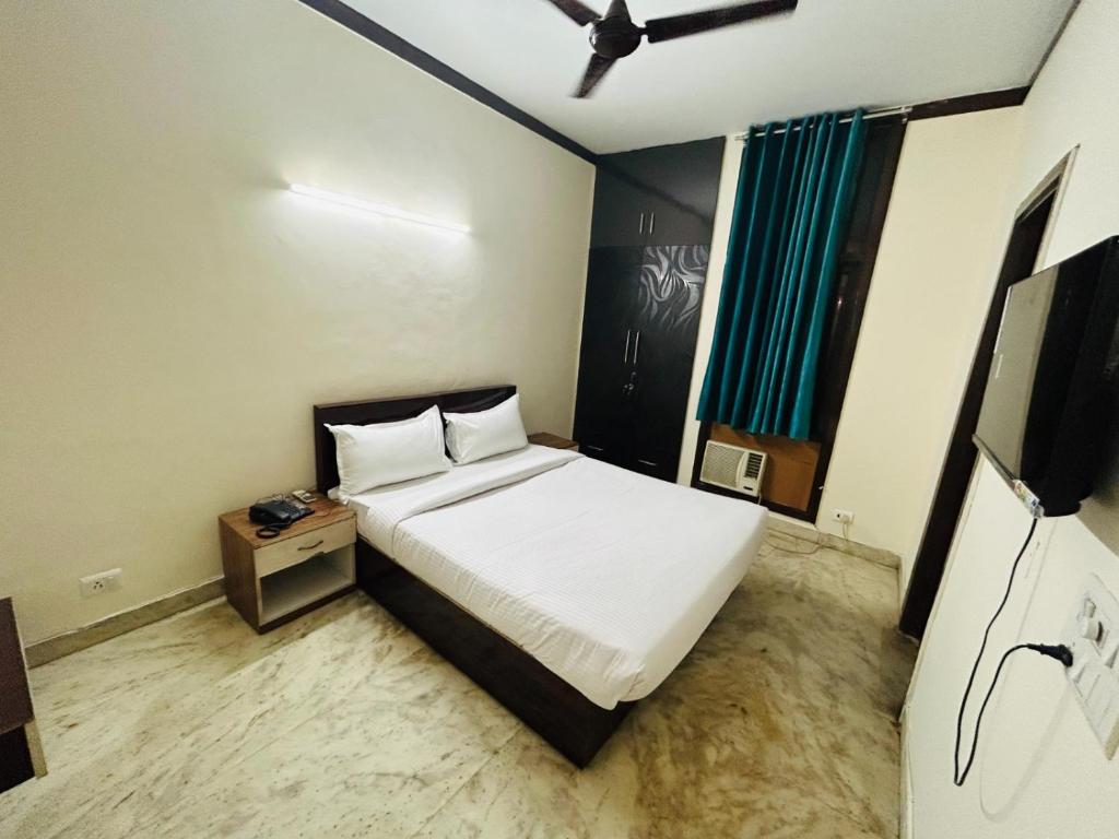 a bedroom with a bed and a tv in it at Luxury Home Stay - Lajpat Nagar in New Delhi