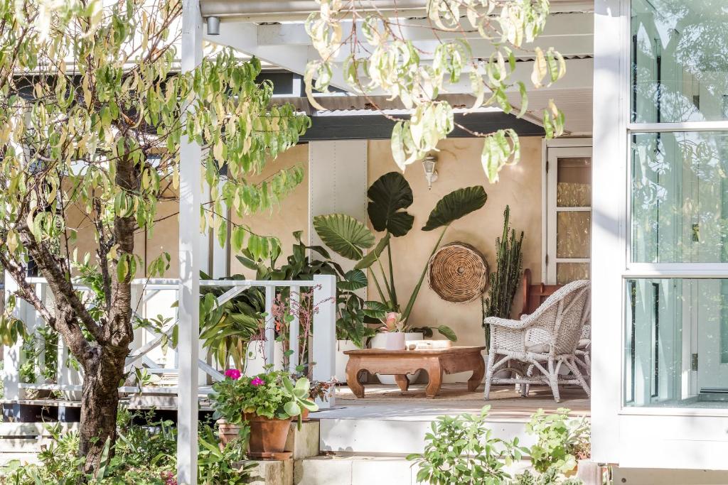 a porch with plants and a chandelier at Hideaway Studio in Dunsborough