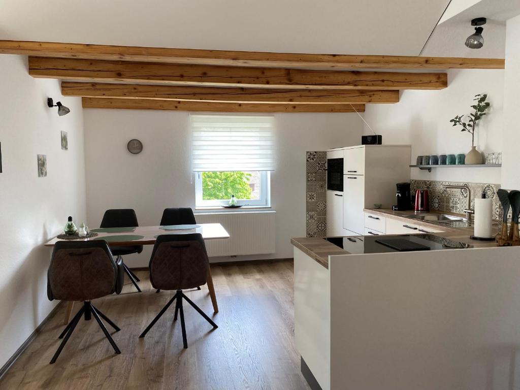 a kitchen with a table and chairs in a room at Haus Mariechen in Frielendorf