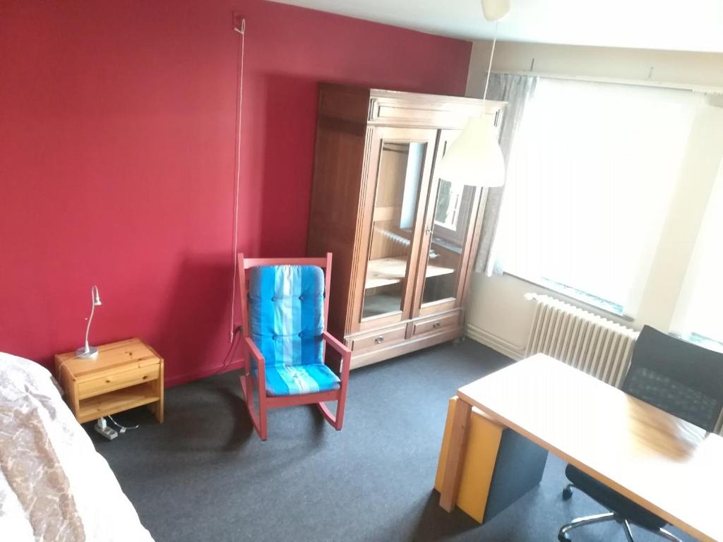 - une chambre avec un lit, un bureau et une chaise dans l'établissement Merxotio, à Gand