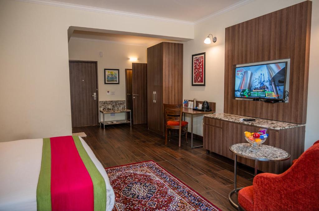 TV a/nebo společenská místnost v ubytování La Oasis by Meraden ,Goa