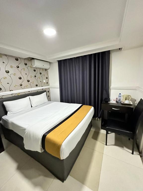 Postel nebo postele na pokoji v ubytování Msquare Hotel GRA