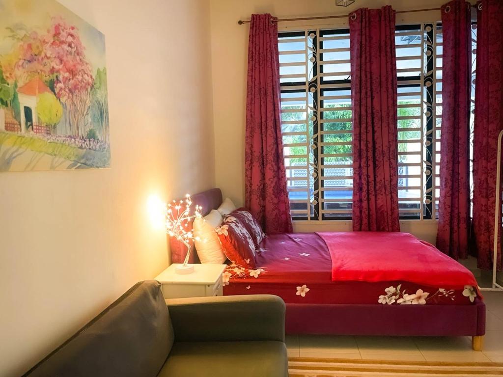 a bedroom with a bed and a window with red curtains at Sulong Inn - Private Pool Homestay in Kuantan, Pantai Sepat in Kuantan