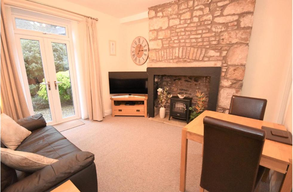 a living room with a couch and a fireplace at The Lobsterpot in Berwick-Upon-Tweed