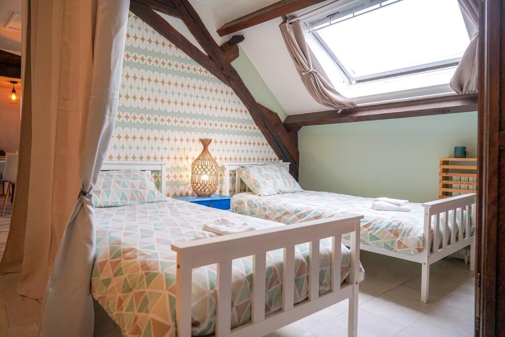 sypialnia z 2 łóżkami i oknem w obiekcie La Suite Cistude ・Charmant ・Cosy w mieście Le Blanc