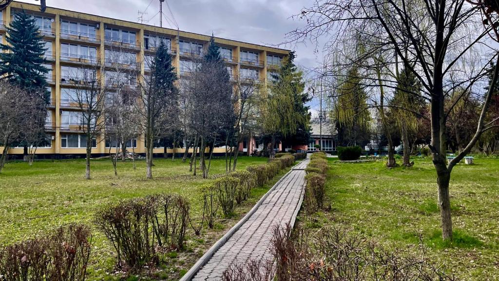 a walkway in a park in front of a building at Sanatoriy Samara 