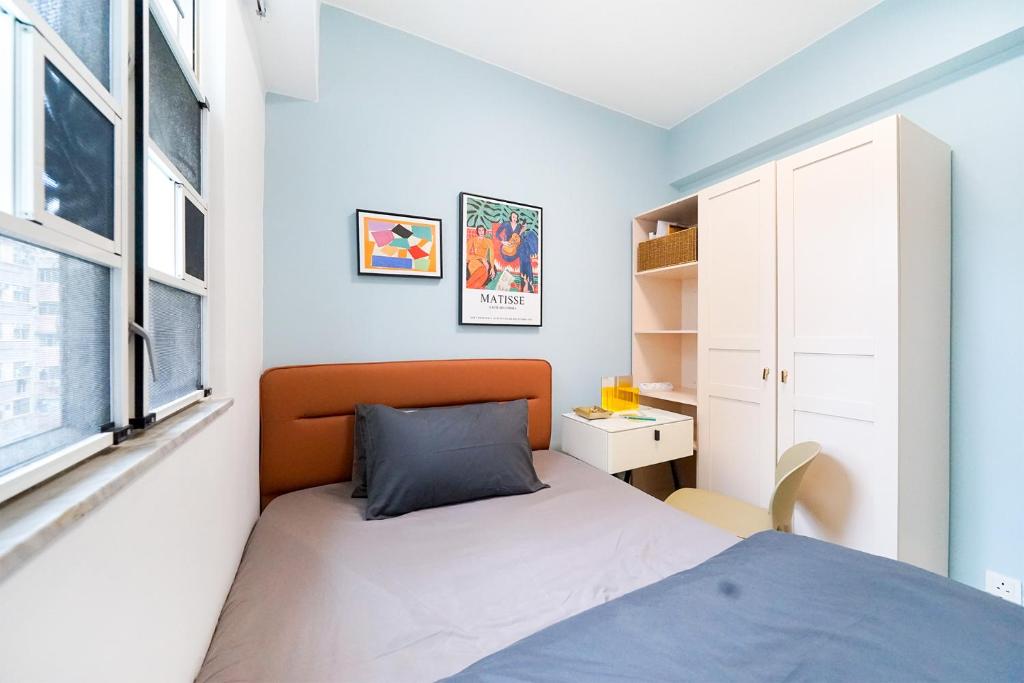 a small bedroom with a bed and a window at Student Accommodation - Lockhart Road 137 in Hong Kong