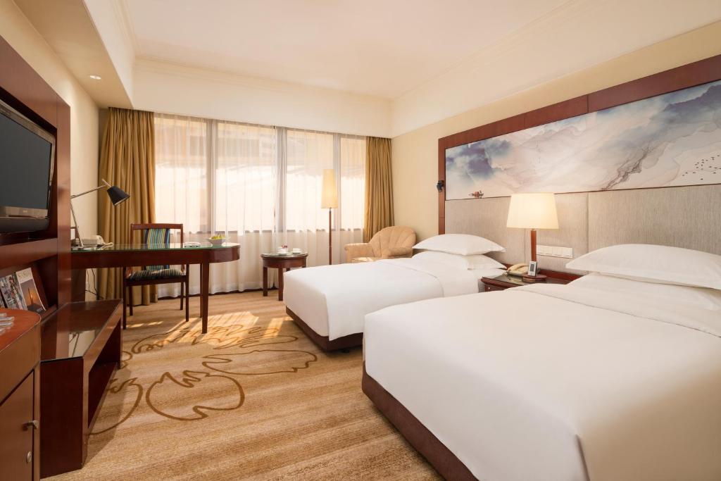 Postel nebo postele na pokoji v ubytování Shenzhen Sunshine Hotel, Luohu