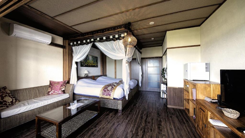 Postel nebo postele na pokoji v ubytování Bali Resort SAYA no Kaze